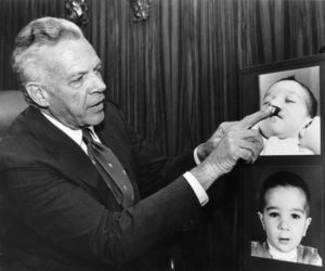 Above - Dr. D. Ralph Millard reviewing before and after pictures of Cleft Lip and Palate surgery. His contribution of the rotation-advancement flap repair remains one of the most significant advancements in the field of congenital lip deformity correction.