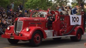 The Davis Town Council riding in a vintage firetruck.